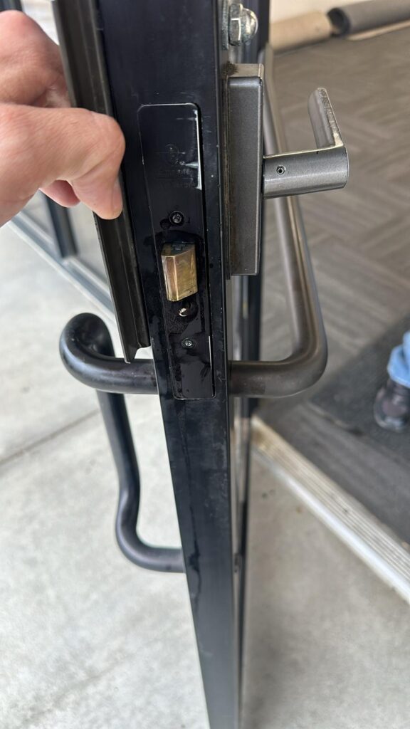 Locksmith work on a commercial door lock