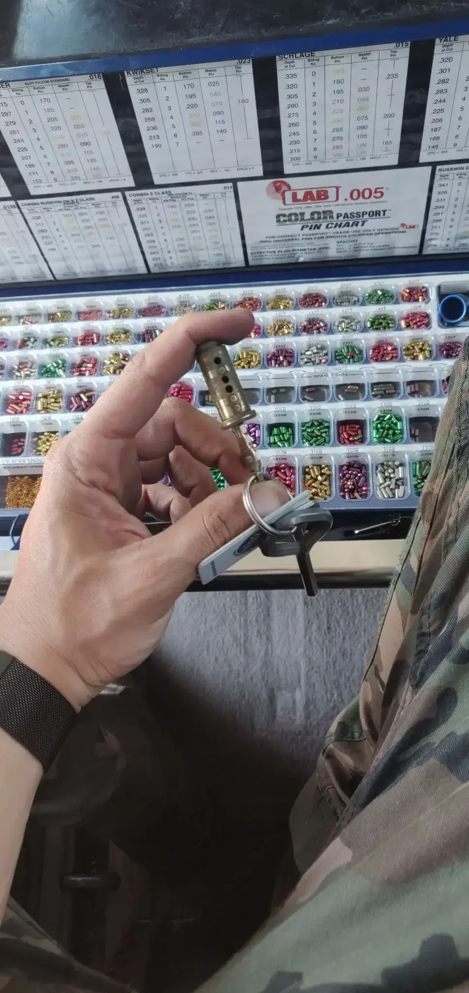 Lock cylinder and key being rekeyed with replacement pins